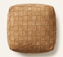 A square woven pouf or ottoman in a warm tan-brown leather-like material, photographed from directly above on a light neutral background.
