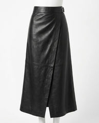 A black leather midi skirt with a wrap-style front and a small belt buckle at the waist, displayed on a white mannequin against a plain white background.