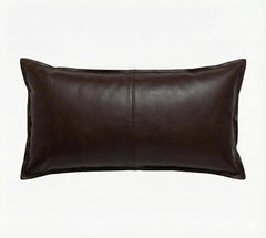 A dark brown genuine leather lumbar pillow with a central seam, shown against a plain white background.