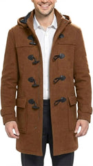 A man wearing a brown hooded duffle coat with black toggle closures over a white collared shirt and dark trousers, shown against a plain white background.