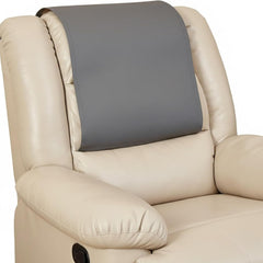 A close-up of a beige leather recliner chair with a dark gray headrest support pillow attached to the backrest.