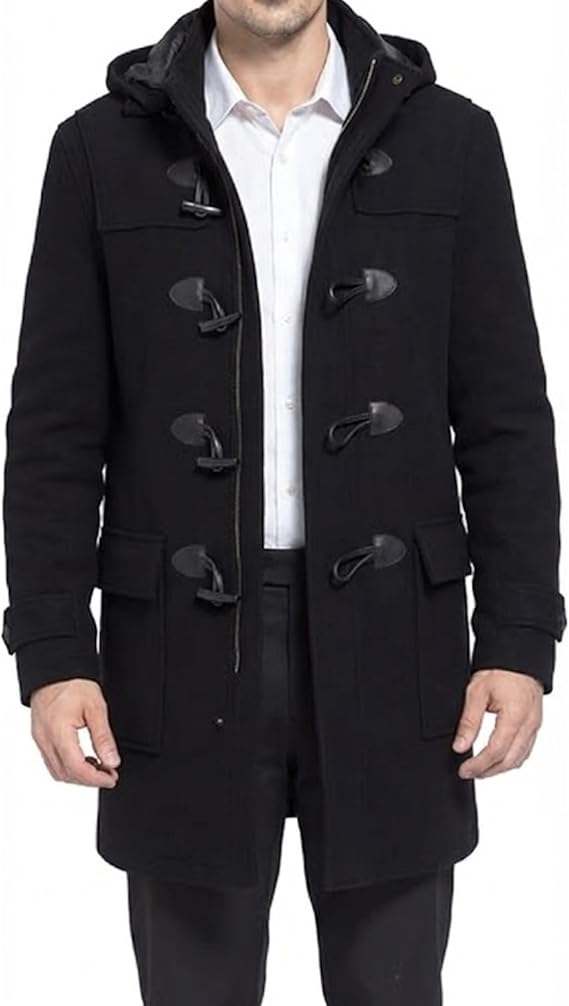 A man wearing a black hooded duffle coat over a white collared shirt and dark trousers, shown from the neck down against a plain white background.