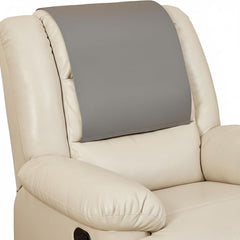 A close-up of a cream-colored leather recliner chair with a gray headrest support pillow attached to the backrest.
