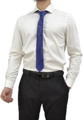 A man wearing a white long-sleeve dress shirt, a blue necktie, a black belt, and dark trousers, shown from the neck down against a plain white background.