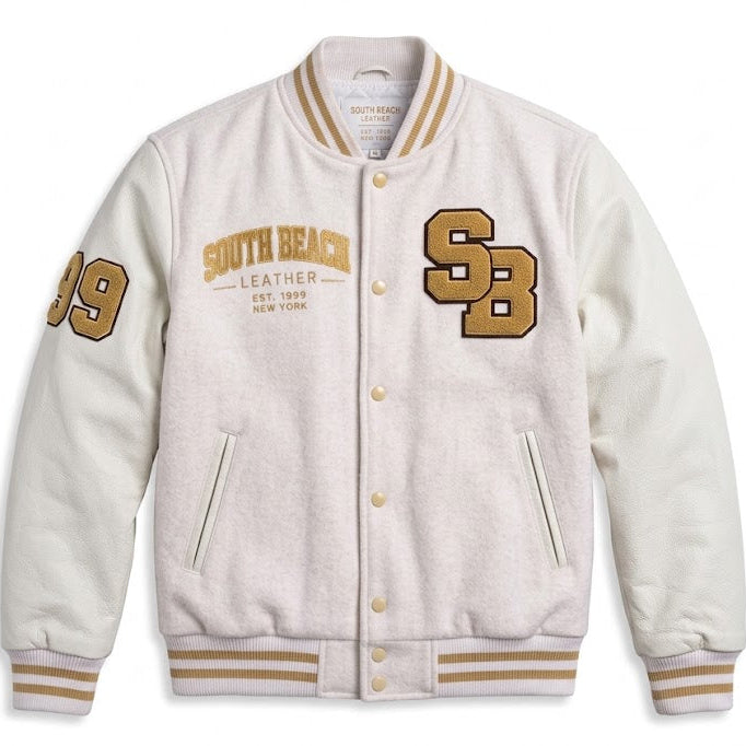 A cream-colored varsity jacket with gold and tan accents, featuring 'South Beach Leather' text and 'SB' lettering on the front, displayed against a solid white background.