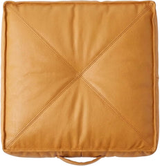 A square tan -leather floor cushion with a stitched X design in the center and a loop handle at the bottom, shown on a plain white background.