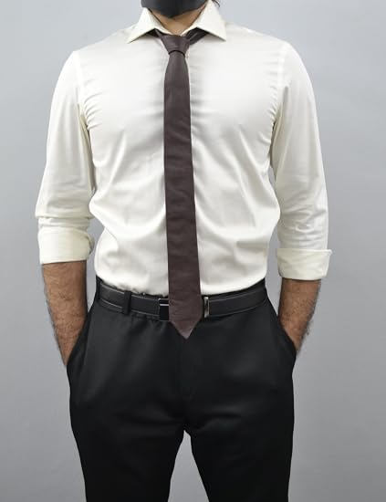 A man wearing a white long-sleeve dress shirt, a dark brown tie, and black trousers, shown from the neck down against a plain gray background.