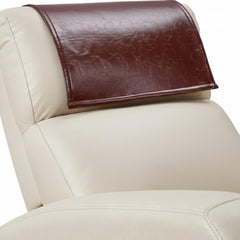 A close-up of a cream-colored leather chair with a dark brown faux-leather headrest cover resting on the headrest.