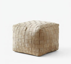 A square woven pouf ottoman in a light tan suede-like material, shown on a clean white background.