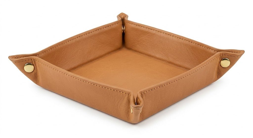 A square tan leather tray with gold snap-button corners, shown on a clean white background.