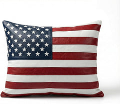 A square throw pillow featuring a faux leather American flag design with red and white stripes and a navy blue canton with white stars, shown on a plain white background.