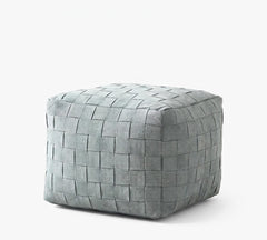 A square woven pouf ottoman in a muted gray-green tone, shown on a clean white background.