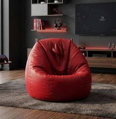 A large, plush red bean bag chair made of smooth faux leather, styled in a modern gaming room setting on a gray shag rug.