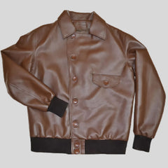 A brown leather bomber jacket with a mandarin collar, front button closures, and a left chest flap pocket, displayed on a plain background.