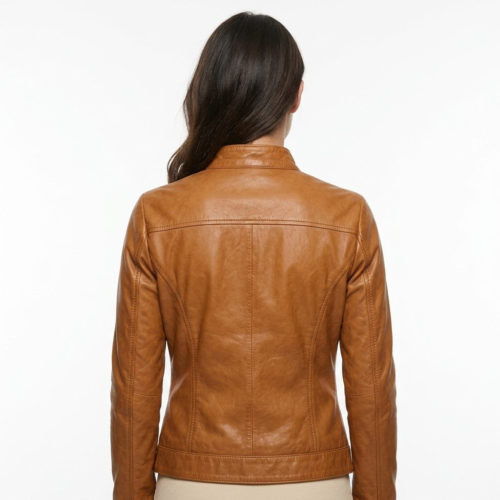 A woman viewed from the back wearing a cropped tan leather jacket against a plain white background.