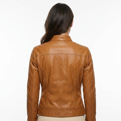 A woman viewed from the back wearing a cropped tan leather jacket against a plain white background.