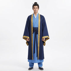 A man wearing a traditional Chinese Hanfu outfit with a navy blue outer robe, light blue inner garments, and gold trim, standing against a plain white studio background.