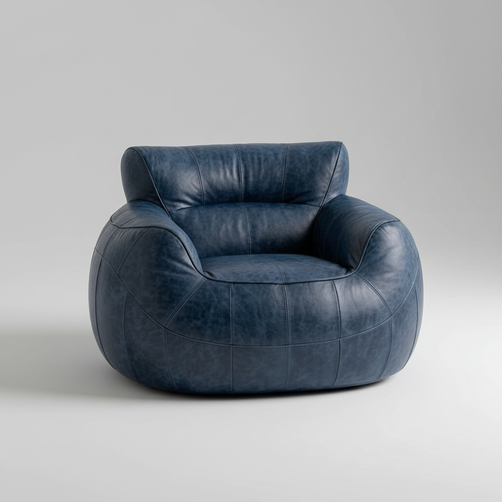 A modern round armchair upholstered in distressed navy blue leather, shown from a three-quarter angle on a light gray studio background.
