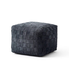 A square woven pouf ottoman in a dark charcoal gray color, shown from a three-quarter angle on a clean white background.