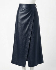 A dark navy blue leather wrap midi skirt with a side slit and a matching belt, displayed on a white mannequin against a plain white background.