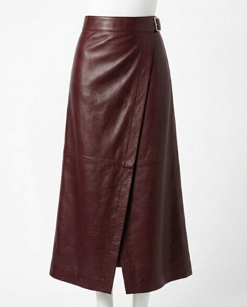 A dark burgundy leather midi skirt with a wrap-style front and a small belt buckle at the waist, displayed on a white mannequin against a plain white background.